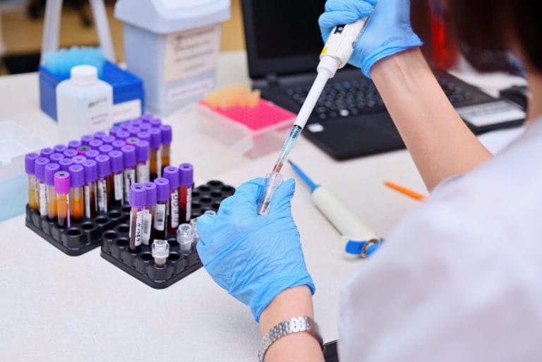 Scientist processing samples with a pipette